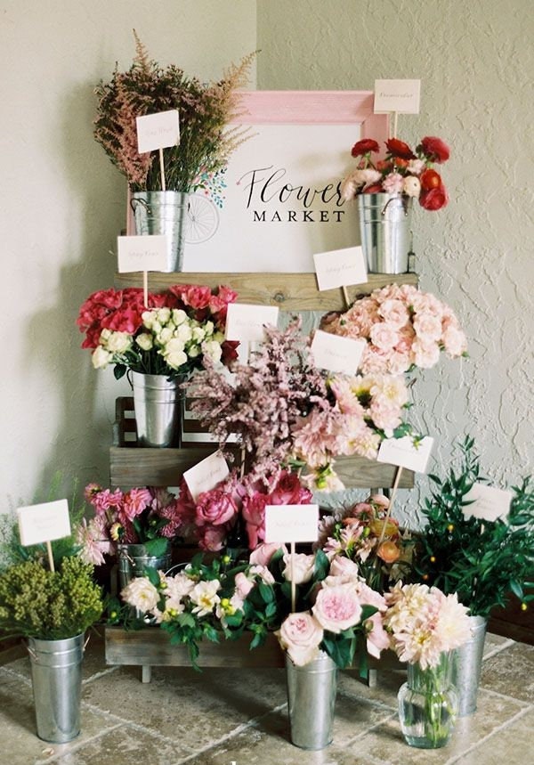 Pre-cut floral wrapping paper sheets, ideal for wrapping bouquets at a bridal shower flower bar.  