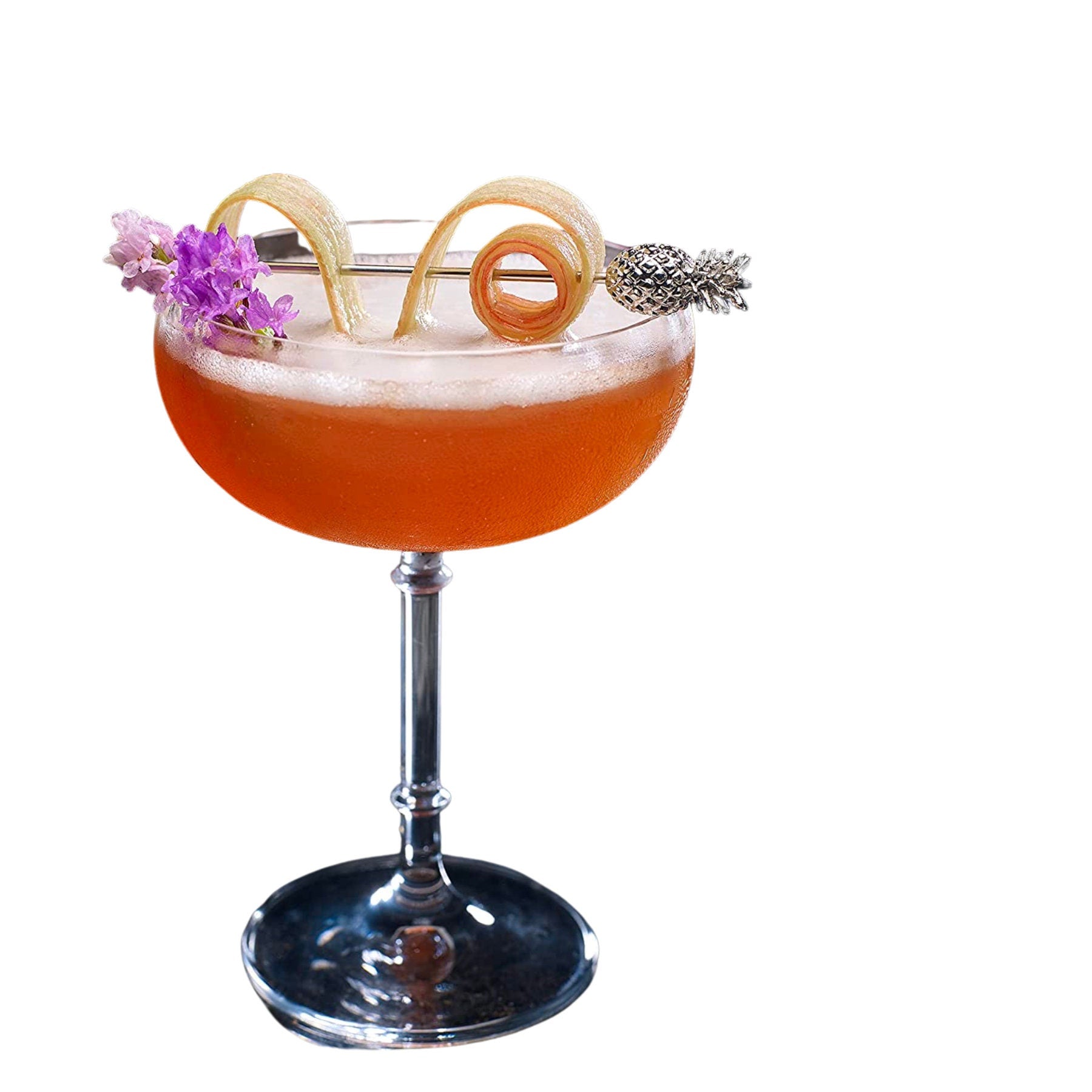 Orange cocktail garnished with spiral peel and pineapple drink stick