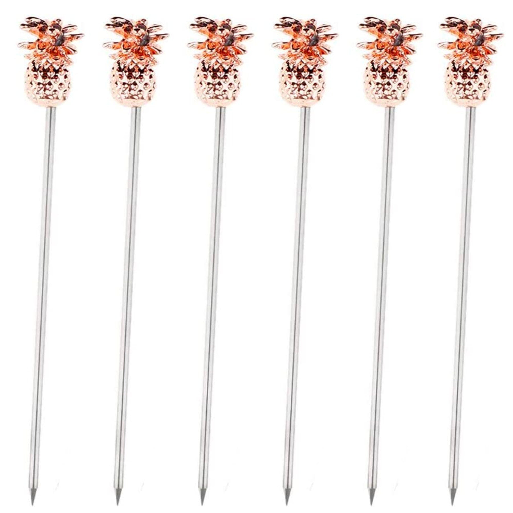 Row of rose-gold pineapple drink sticks on white background