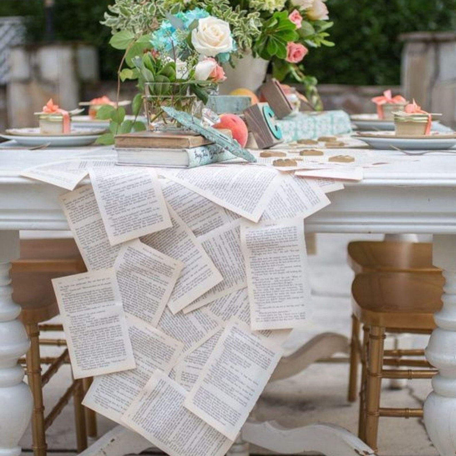 Rustic table runner made from vintage book pages at a wedding reception.