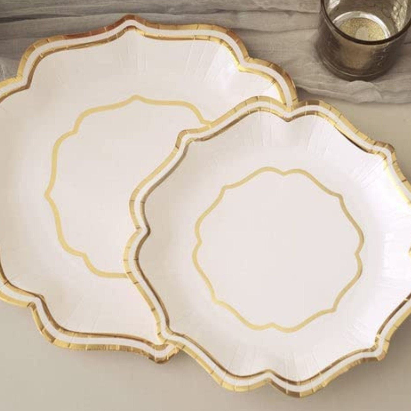 Elegant silver scallop rim disposable plate displayed on table setting