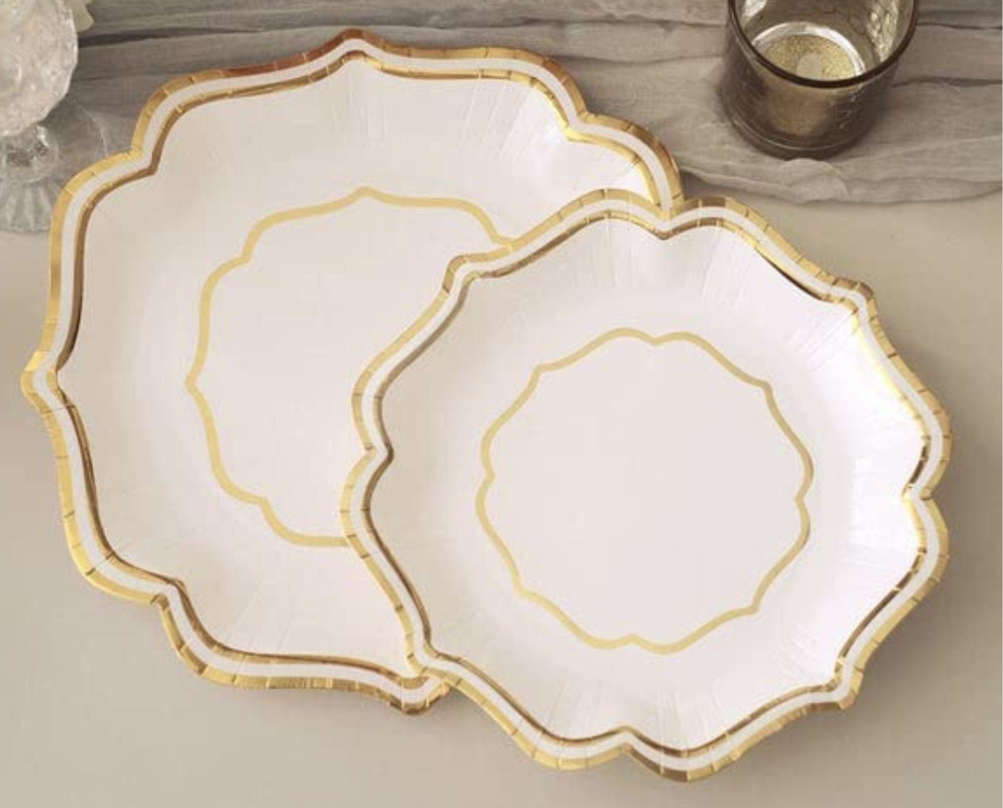 Elegant silver scallop rim disposable plate displayed on table setting