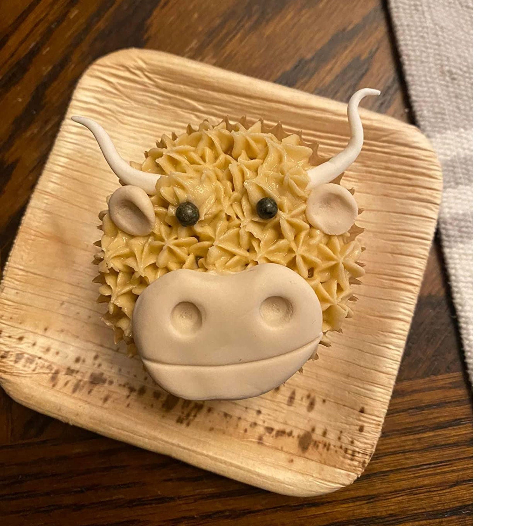 Cupcake on square bamboo plate at an event place setting