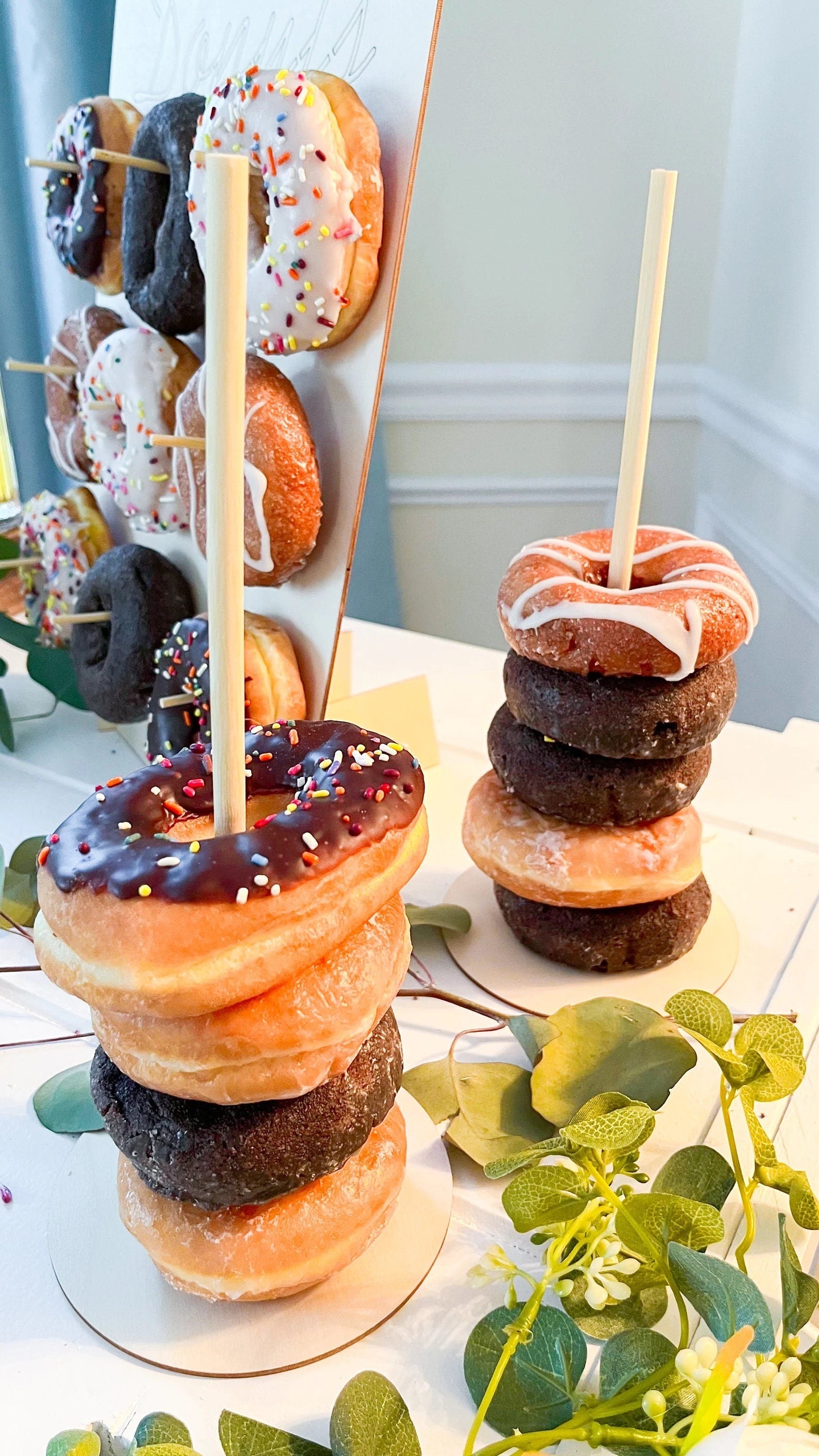 Close-up of vertical stacking donut stand with a tower of glazed donuts