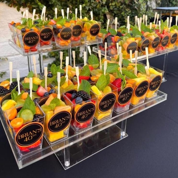 Three-tier clear acrylic display stand showcasing elegant dessert presentation