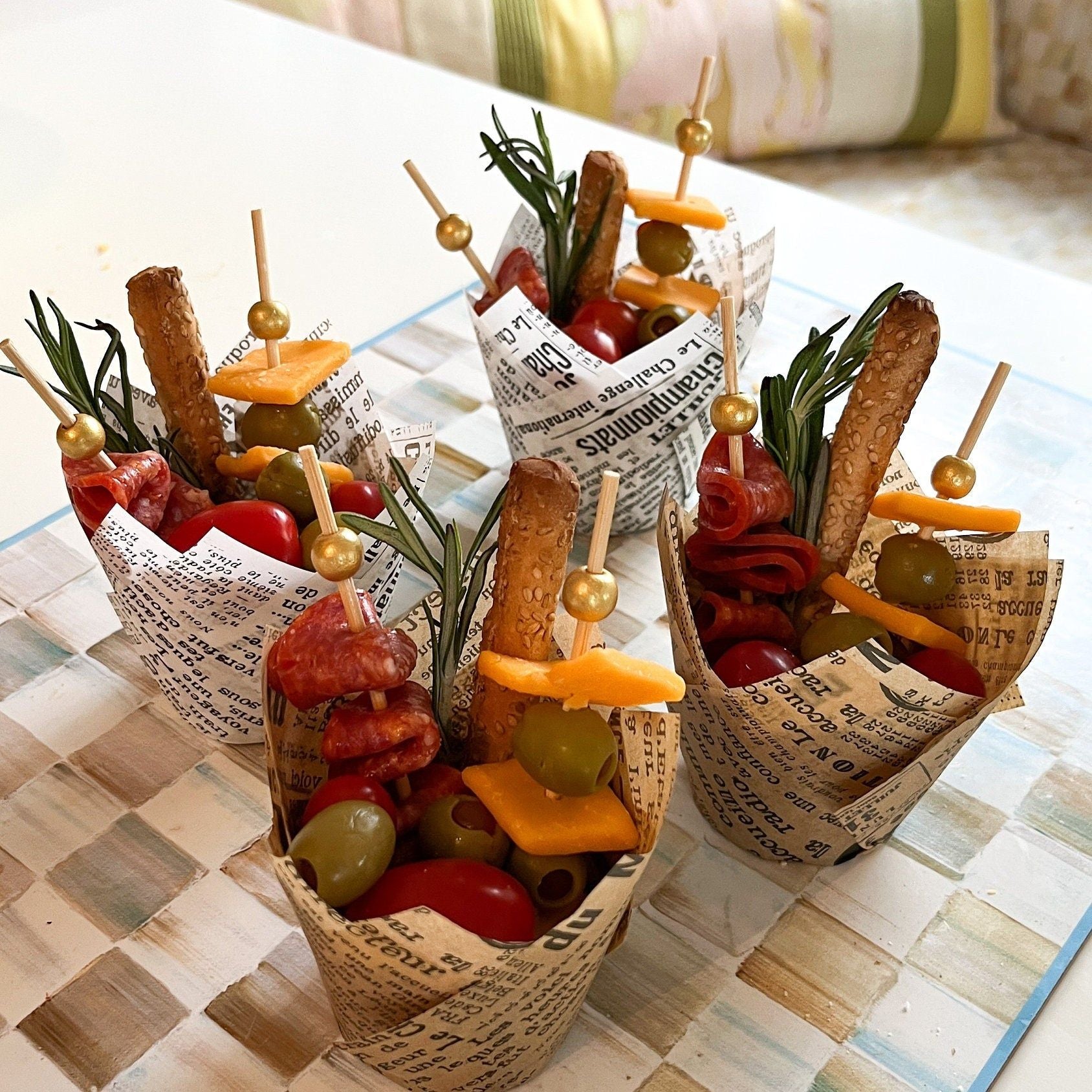 Vintage themed party setup showing multiple charcuterie cups filled with desserts and hors d'oeuvres