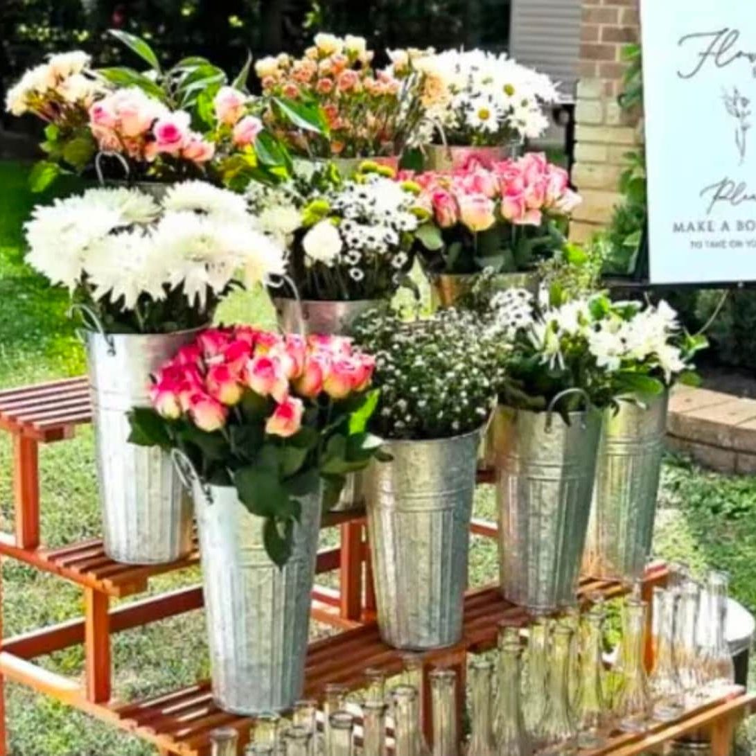 Tin flower buckets with a vintage design, perfect for creating a stunning DIY flower bar arrangement.  