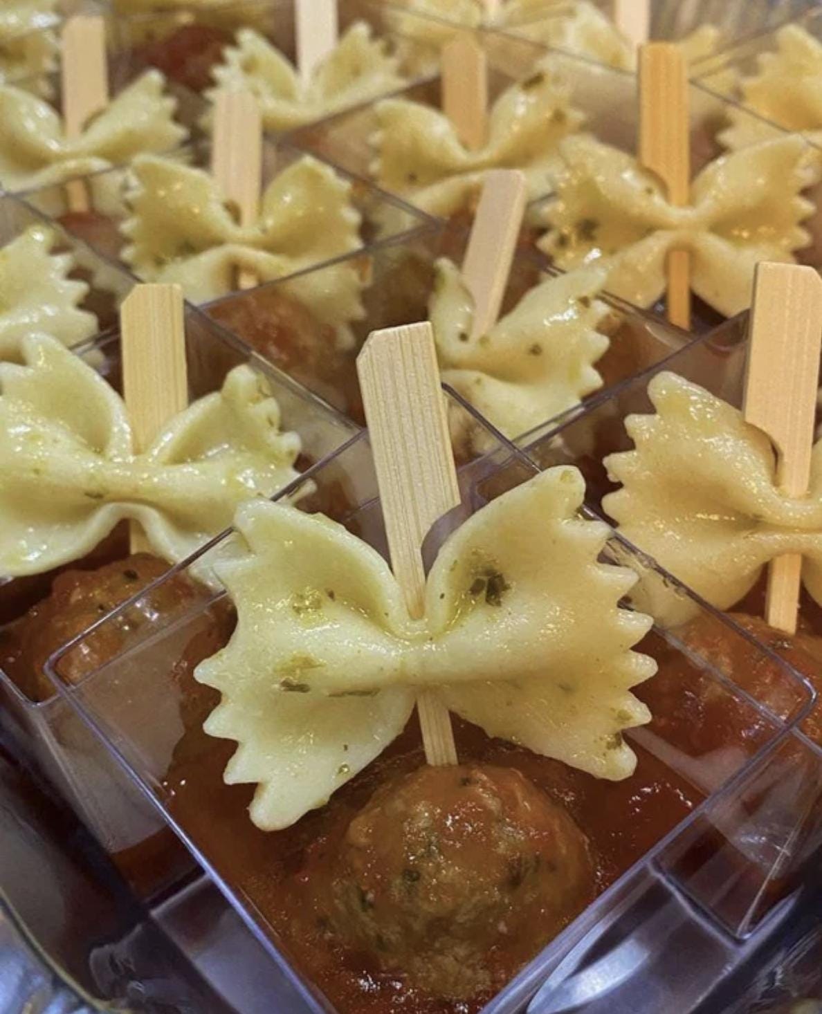 Disposable wooden charcuterie cups with cheese, berries, and cured meat. Eco-friendly appetizer cones.