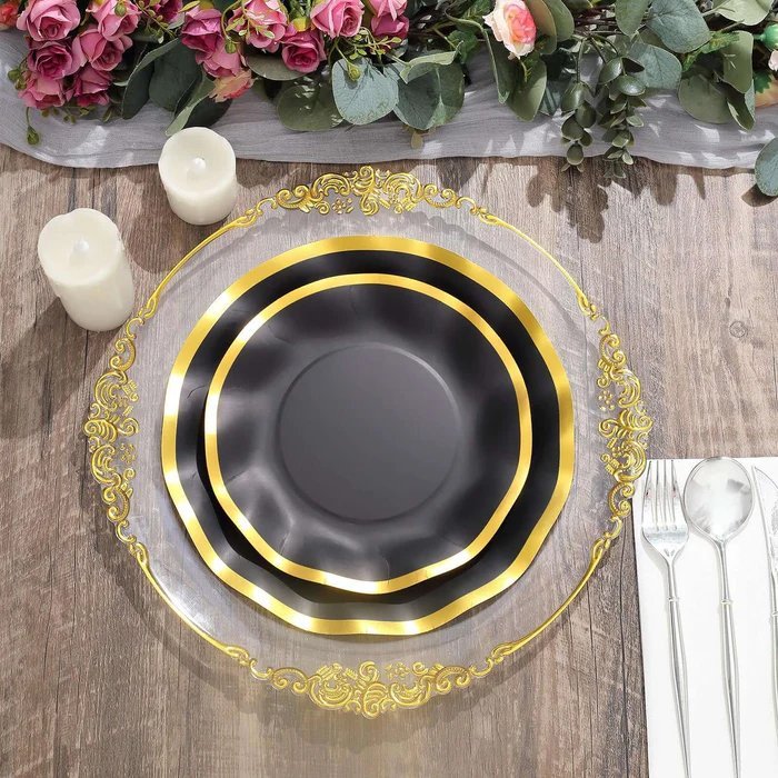White round plastic serving bowl with a decorative gold baroque rim. Disposable wedding tableware.