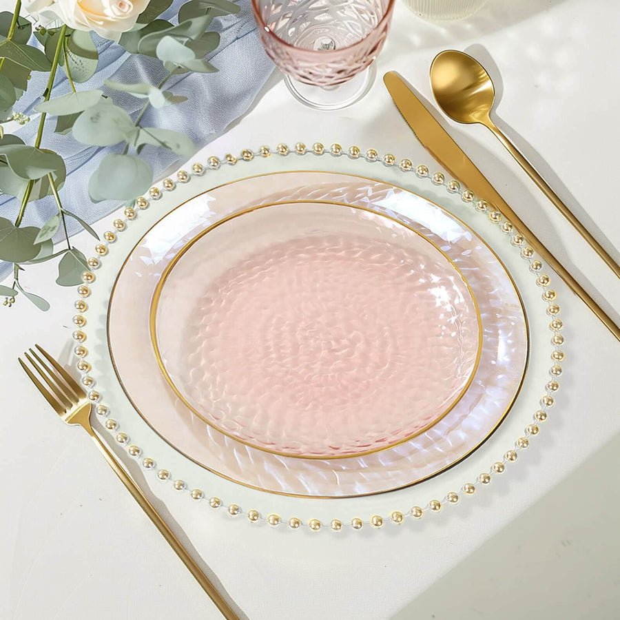 Clear baroque charger plate with ornate gold rim, set with dusty rose plastic dinnerware.