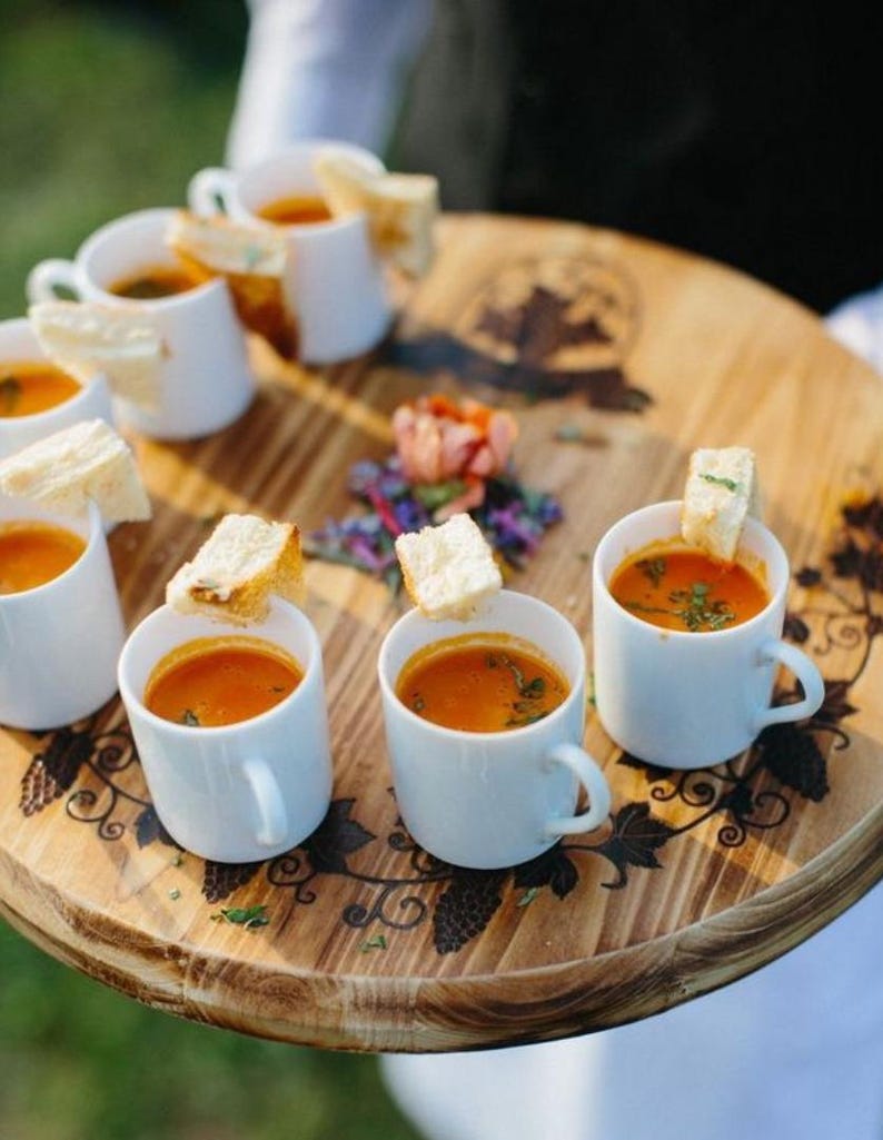 Soup tasting cups on charcuterie board