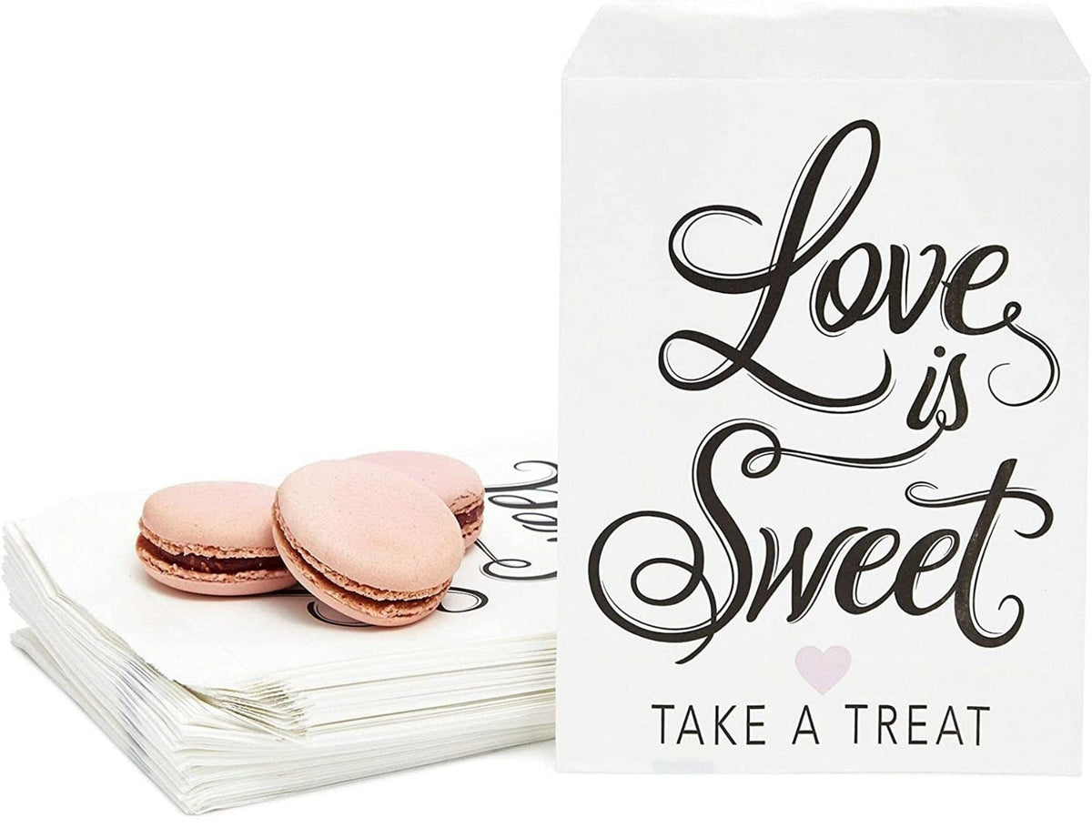 Wedding favor bags with "Love is Sweet" text, featuring macarons. Disposable treat sacks for a dessert bar.