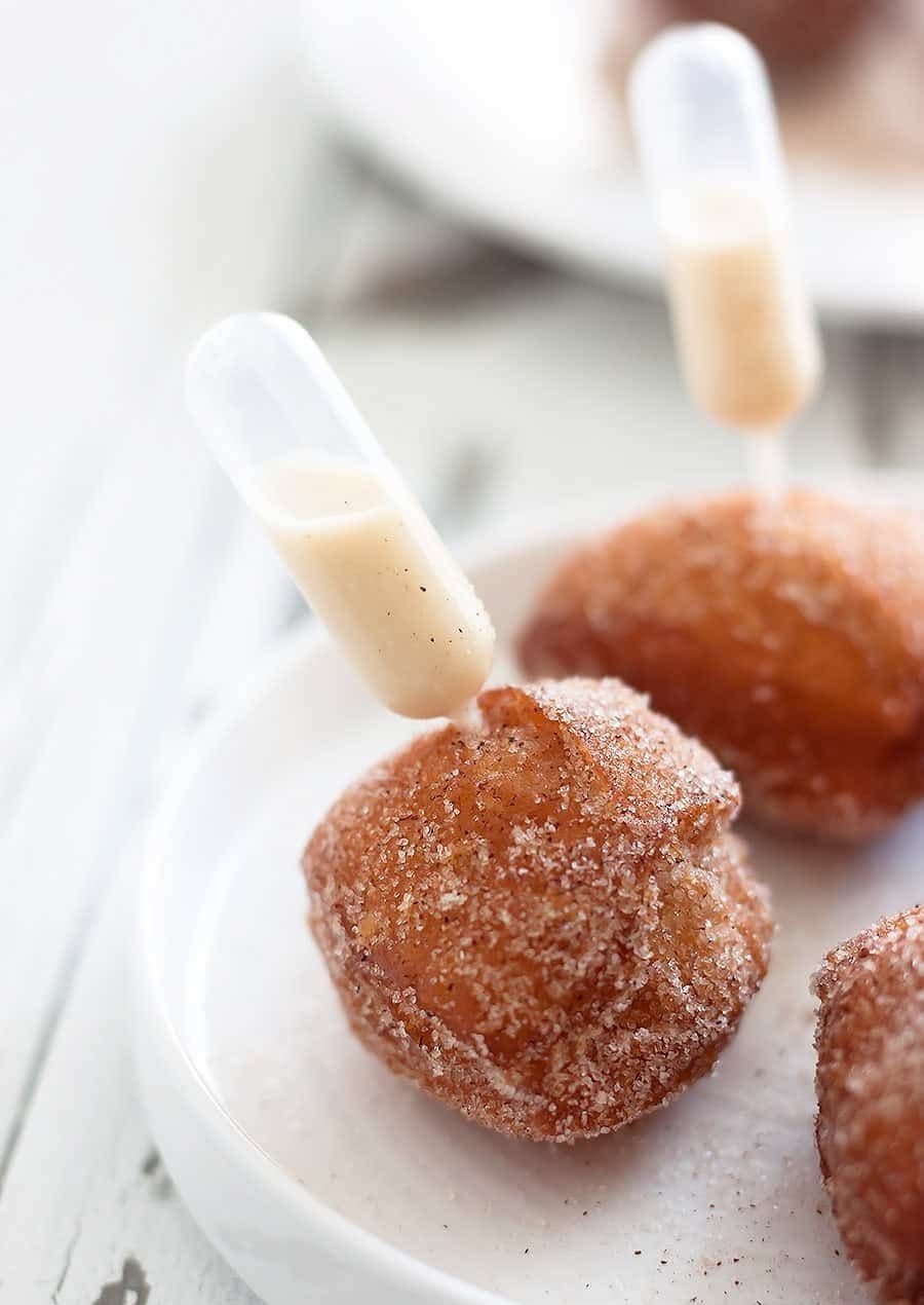 Icing in a mini pipette inserted into a mini donut