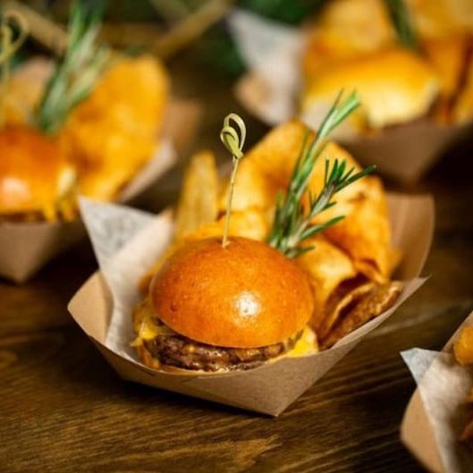 Kraft paper food tray filled with appetizers and wooden toothpicks for elegant party serving.