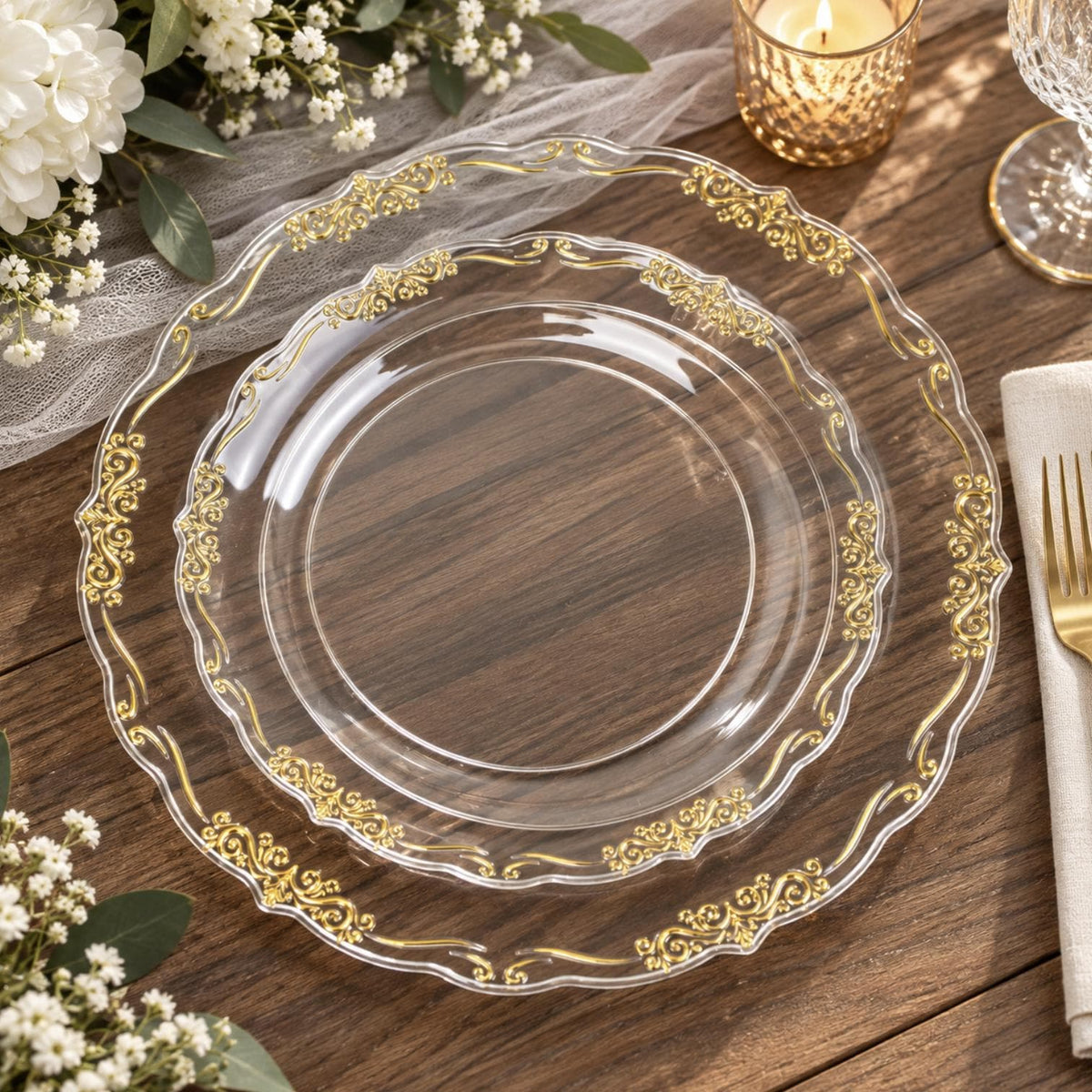 White round disposable plastic plate with decorative gold baroque rim. Elegant wedding tableware.