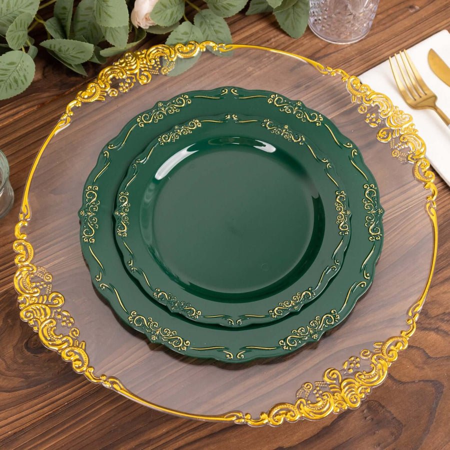 Clear baroque charger plate with gold rim set with pink hammered dinner plate. Disposable wedding tableware.