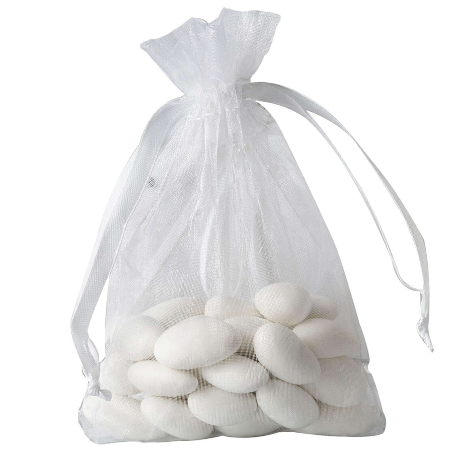 White organza drawstring gift bag filled with colorful candies – elegant packaging for wedding favors and party gifts